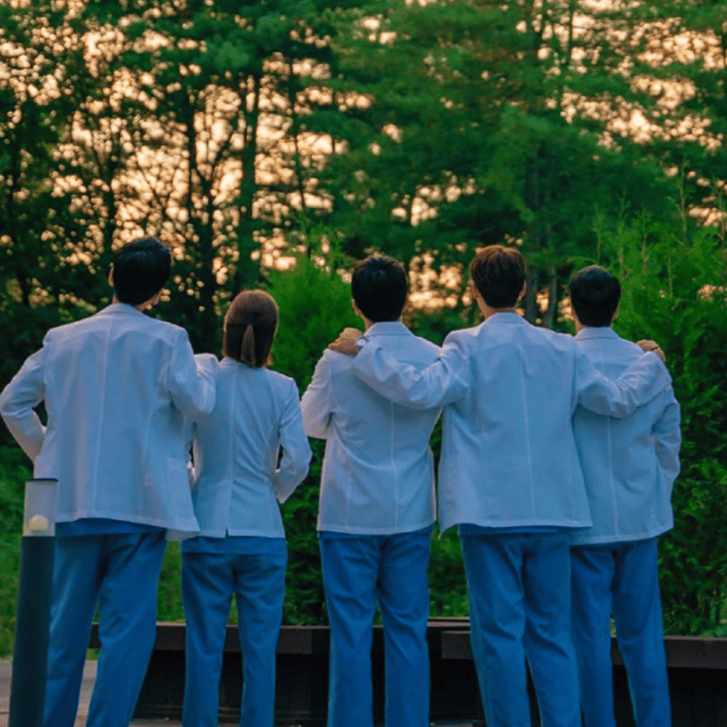 Hospital Playlist TvN promo image of doctors standing in a line with their backs to the camera, symbolizing camaraderie central to Kdramas like You and Everything Else.