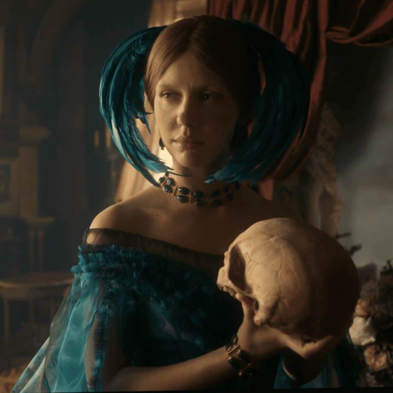 Frankenstein Netflix Review: Still of Elizabeth in a green gown and jeweled headdress, holding a skull