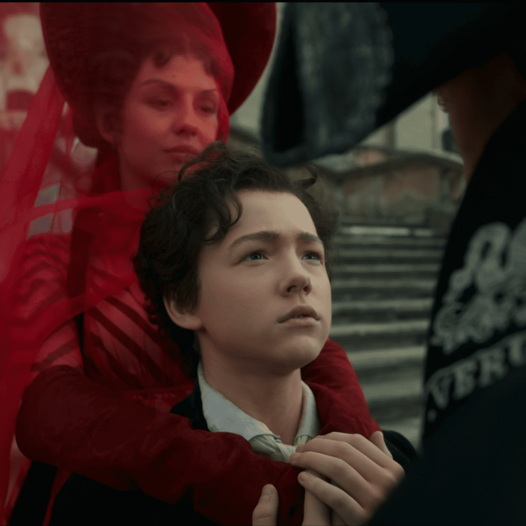 Frankenstein Netflix Review: Young Victor with his scarlet-clad mother greeting his father