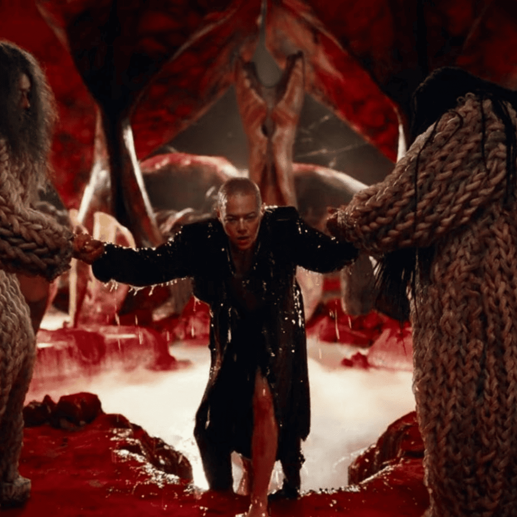 Bugonia Review: Michelle being helped aboard the Andromedan spacecraft after humanity’s extinction.