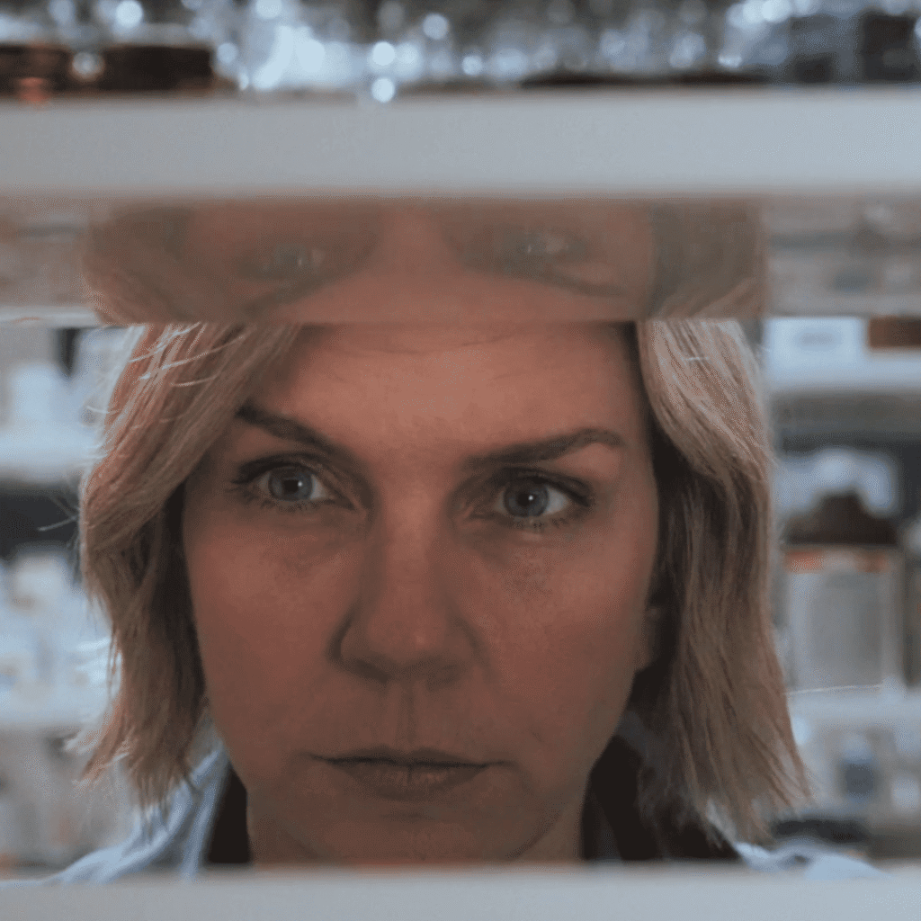 Pluribus Explained: Carol searches the pharmacy shelves, looking for truth serum among the remaining supplies.