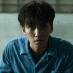 Tae-joong sitting in the prison visit room realizing he has been framed, featured in The Manipulated Review.