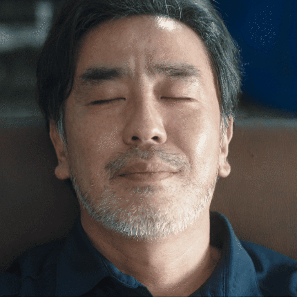 The Dream Life of Mr. Kim Review: Close up showing Mr. Kim in the final scene, reflecting on everything he has lost and rediscovered.