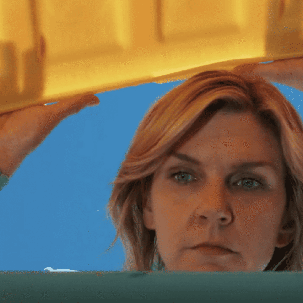 Pluribus Explained: Carol stands over the recycling bins again, quietly absorbing the reality of dwindling resources.