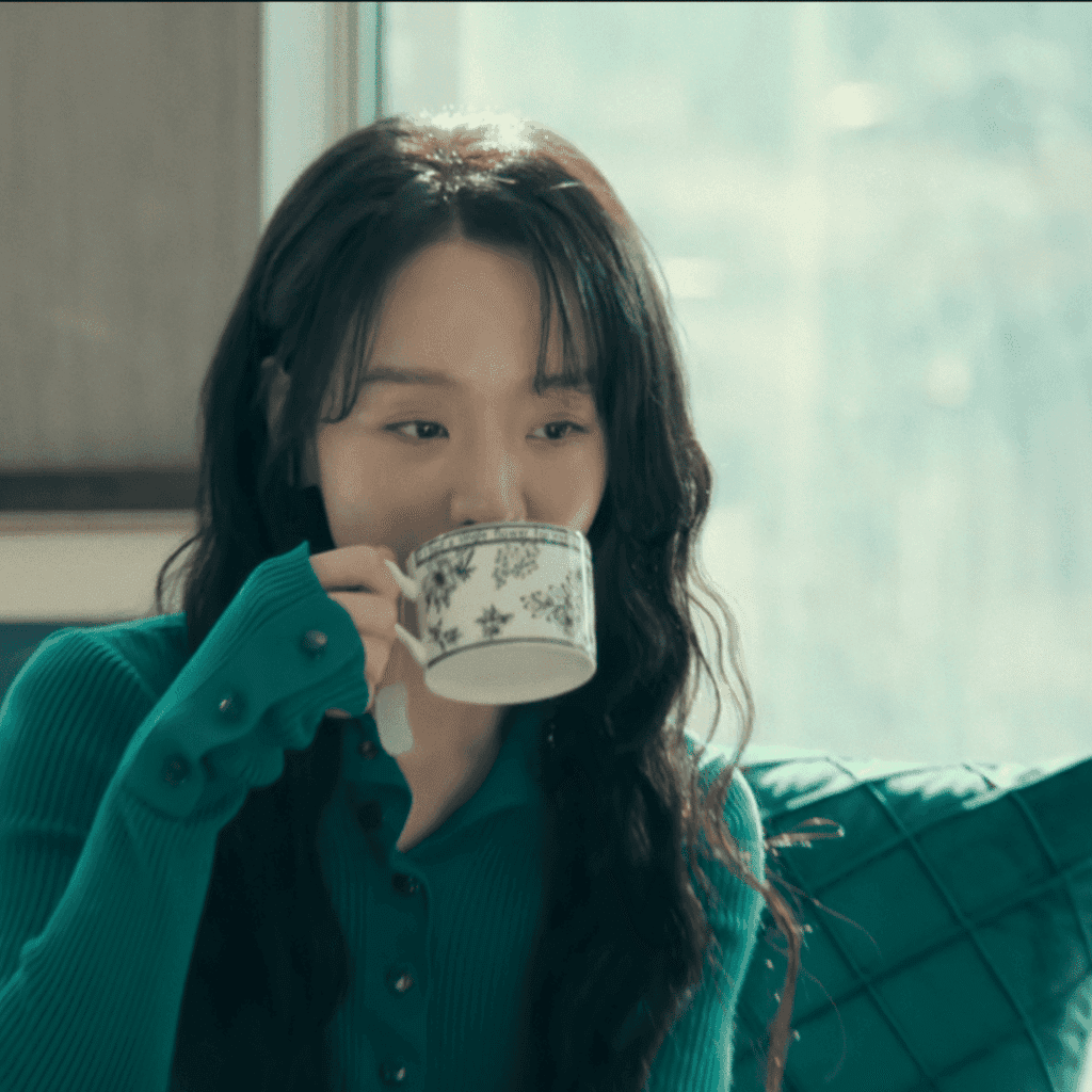 Still of Sarah Kim sipping tea from the finale of The Art of Sarah Review.