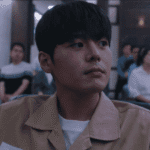 Bloody Flower Review: close up of Lee Woo-gyeom smirking in court