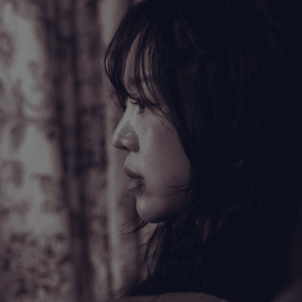 Profile shot of Sarah Kim with a bruised face after being attacked, a study in vulnerability for The Art of Sarah Character Analysis.