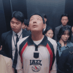 Su-jong standing in a crowded elevator, symbolizing the "descent into madness" at the heart of Mad Concrete Dreams First Impressions.
