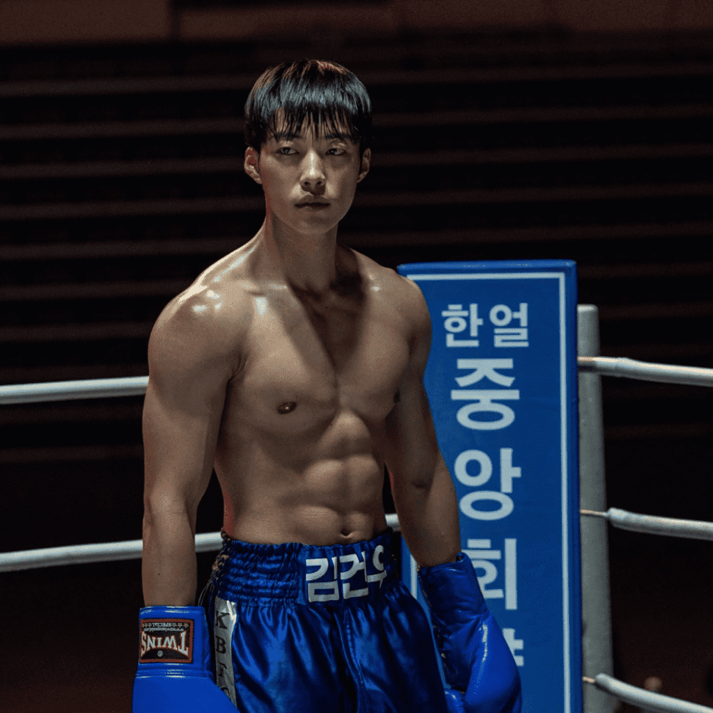 A cinematic shot from the Bloodhounds Season 2 Review of Geon-woo in blue fighting gear, momentarily isolated in the corner of the ring.