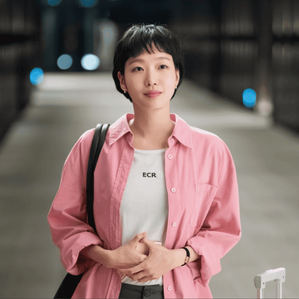 A still shot for the Yumi’s Cells Season 3 review featuring Yumi in a pink shirt standing at the train station as her romantic interest arrives.