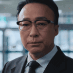 A gritty close-up character still of Choi Gang-seok, analyzed in our Teach You a Lesson review.