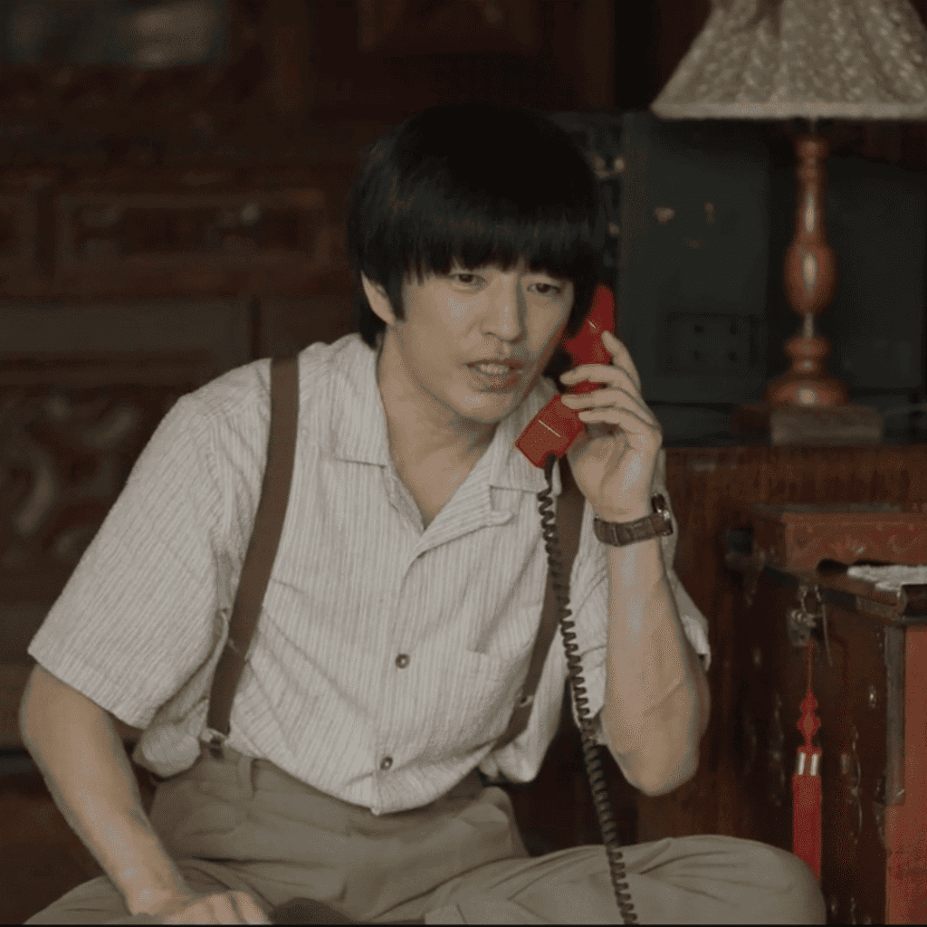 Lee Ki-hwan making a calculated phone call in this scene from The Scarecrow 2026 review.