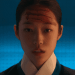 A close-up character still from The East Palace mid-season review showing Saeng-gang with blood smeared across her forehead against a deep blue background.