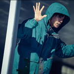 Je Moon-jae in a green hoodie looking out an apartment window in our Mousetrap K-drama review.