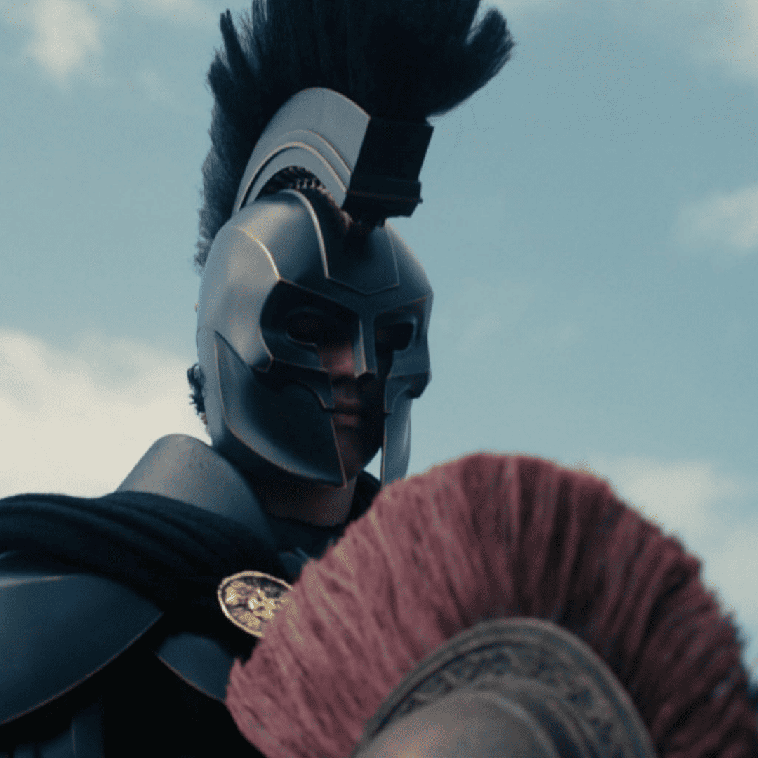 Agamemnon wearing his iconic helmet against a blue sky to recruit Odysseus in this The Odyssey movie review.
