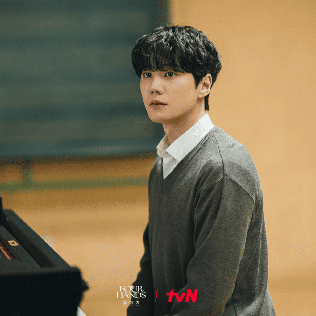 Alt Text:
Choi Jeong-yo sits in his school uniform at a piano in Four Hands, Two Sonatas.